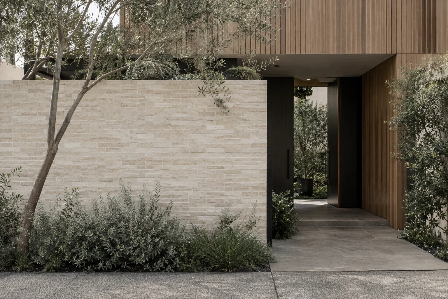 Pale brickwork and timber frame a quiet Australian courtyard entrance
